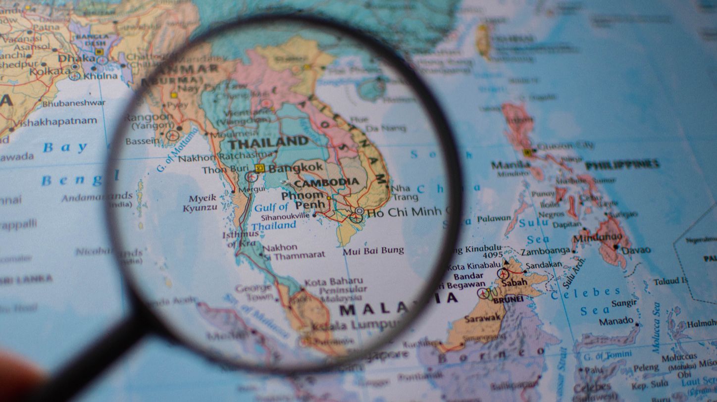 Artist's conception of a large-scale land bridge connecting two coastlines with shipping ports and extensive infrastructure.