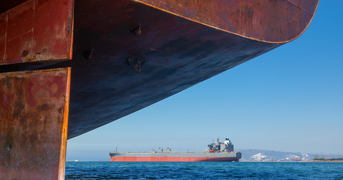 A freighter ship navigating rough seas, symbolizing supply chain disruption.