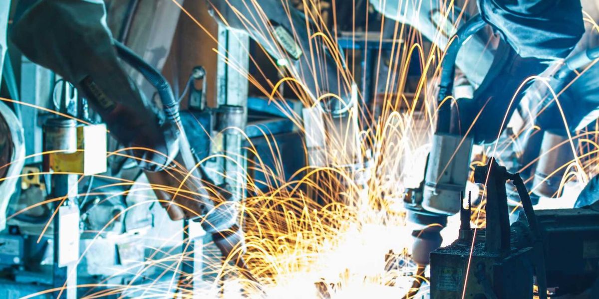 European factory machinery facing stacks of US tariff documents and rising cost charts