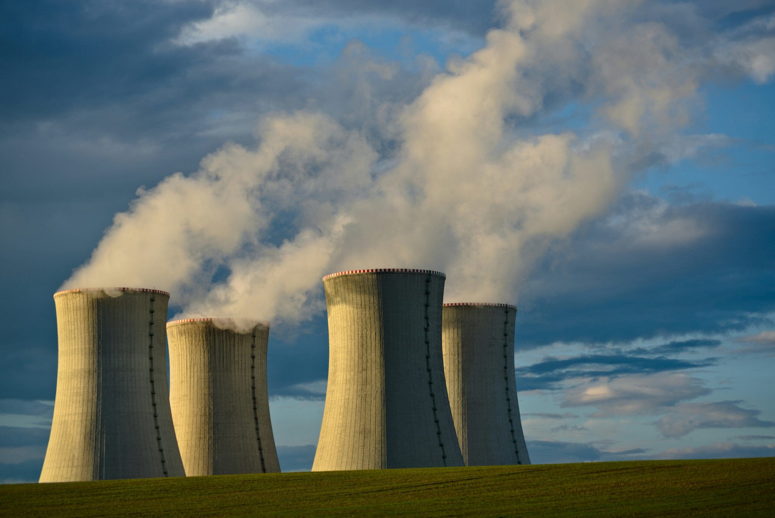 Conceptual image of a modern nuclear reactor near a large data center facility, symbolizing the intersection of AI infrastructure and energy.