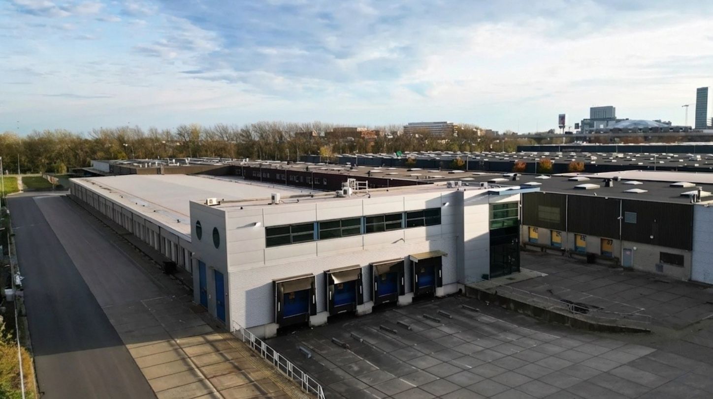 Modern warehouse at Gyroscoopweg Amsterdam with loading docks and Profimaat branding