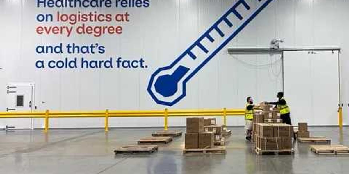 Exterior view of a modern Geodis logistics facility with trucks parked outside.
