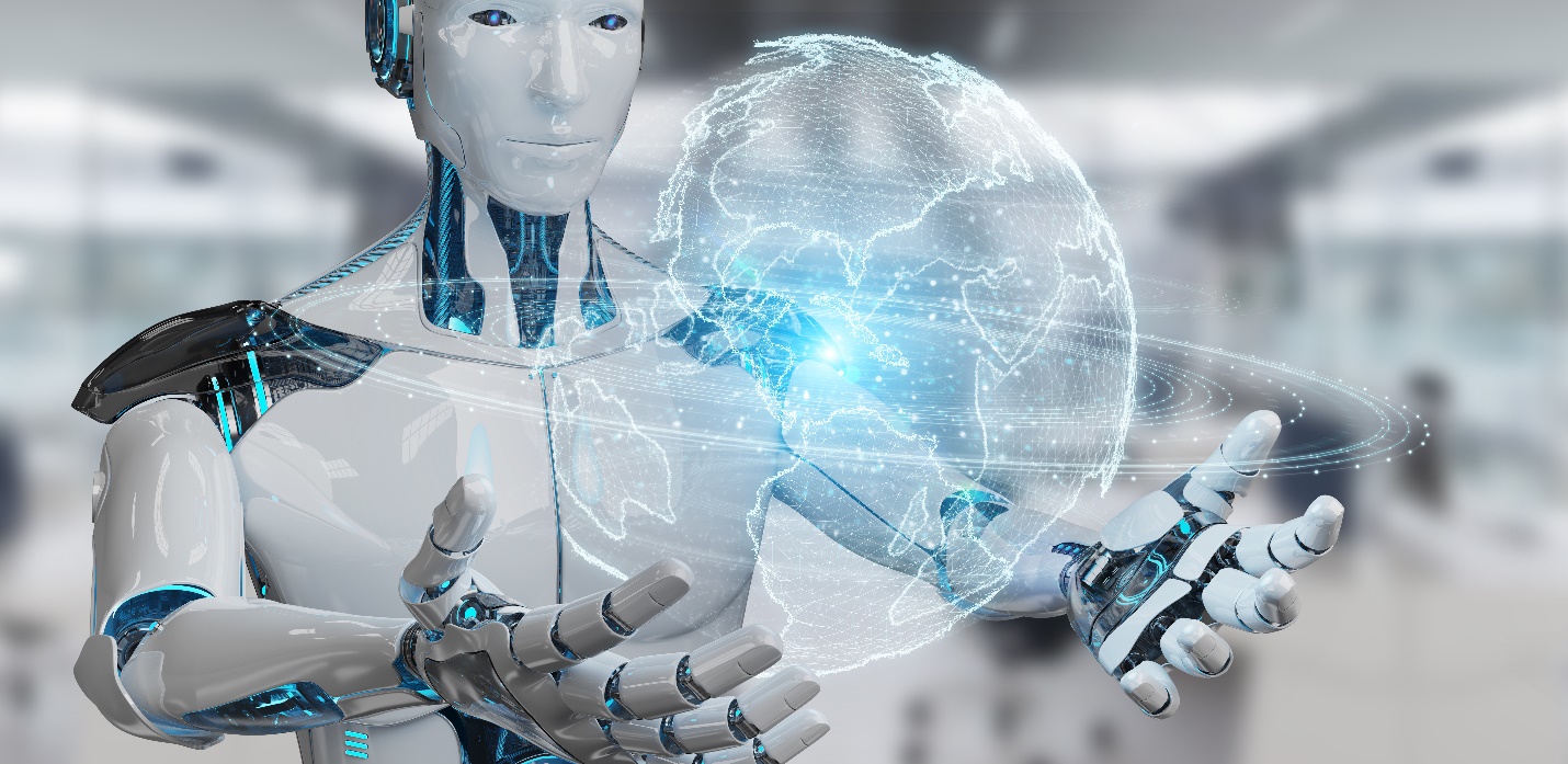 A sleek humanoid robot with glowing blue eyes stands in a modern, light-filled workshop, observing its surroundings with a sense of intelligent awareness.