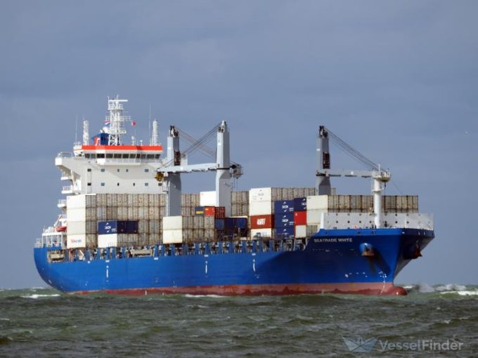 Container ships sailing in a convoy, suggesting high utilization.