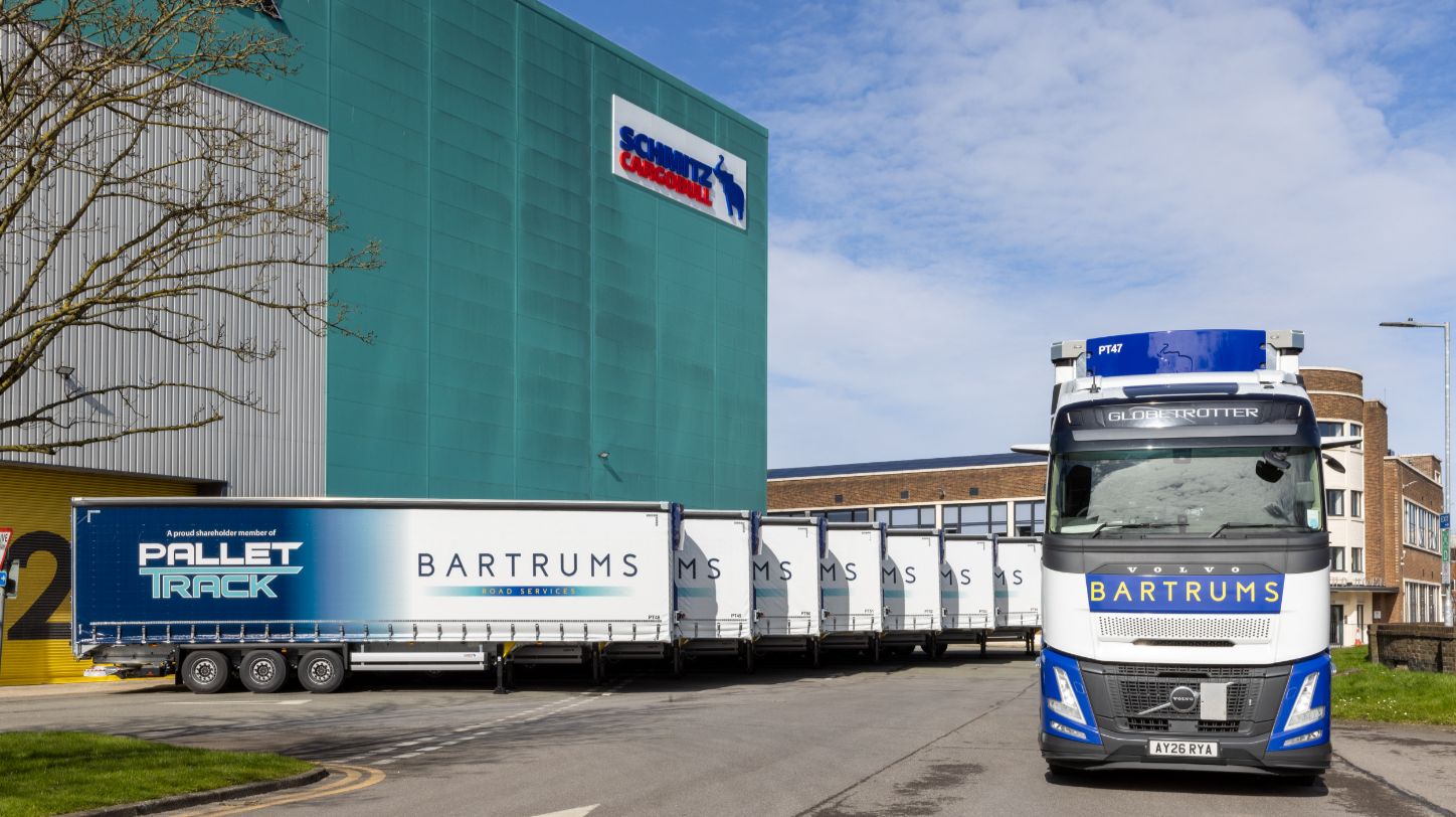 A dual-branded Bartrums and Pallet Track semi-trailer parked at a logistics depot.
