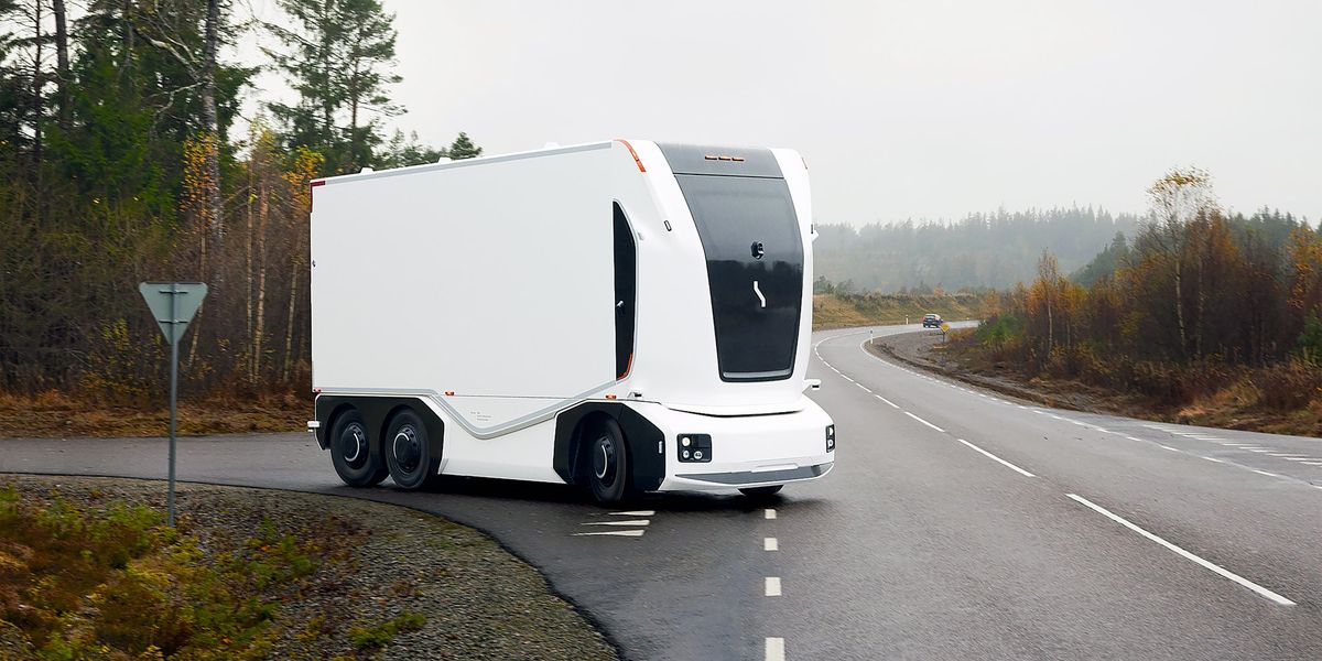 An electric heavy goods vehicle (eHGV) being charged at a depot with complex cable systems and monitoring equipment.