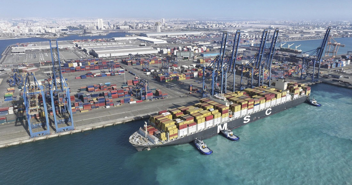 Container ships navigating a narrow waterway, with a truck symbol overlaid to represent the new land route.