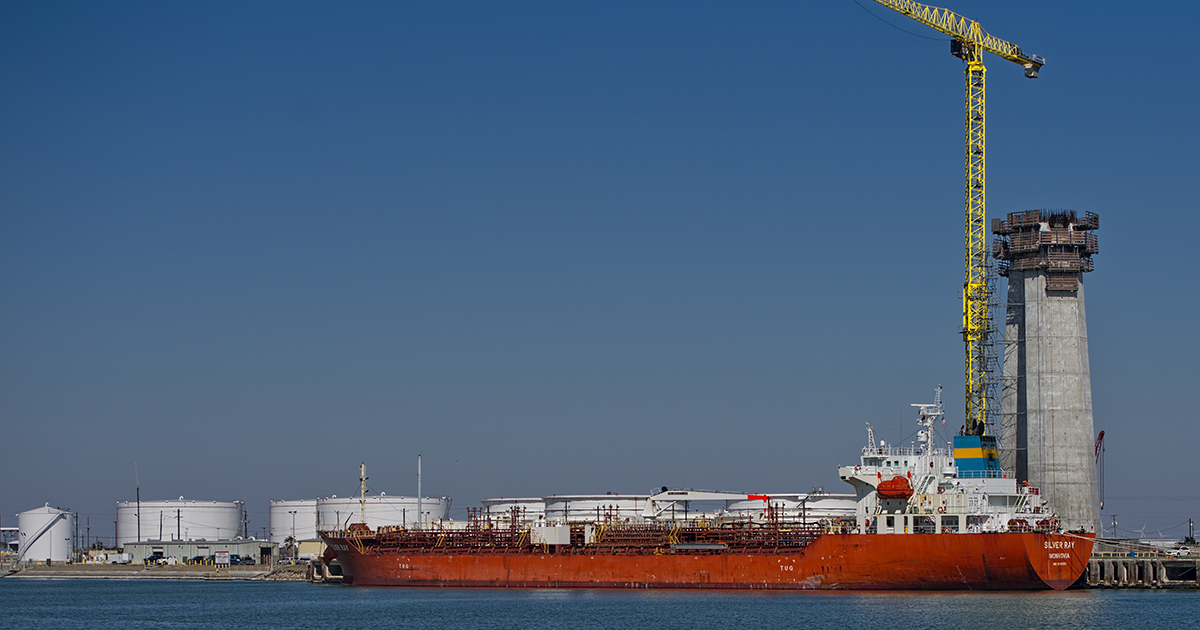 A cargo ship loaded with oil products sails on the ocean.