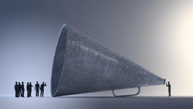 Hapag-Lloyd CEO Rolf Habben Jansen speaking into a microphone.