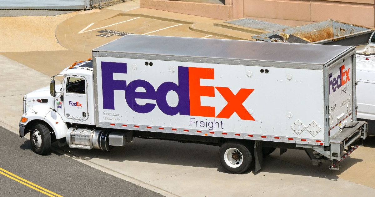 FedEx Freight truck at service center with digital CRM dashboard overlay