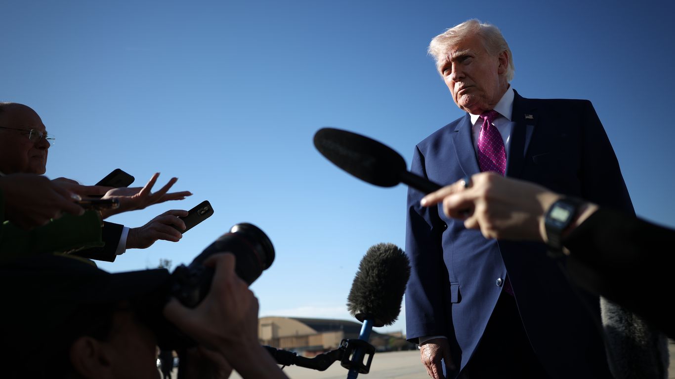 Naval ships patrolling a narrow strait of water under a cloudy sky.