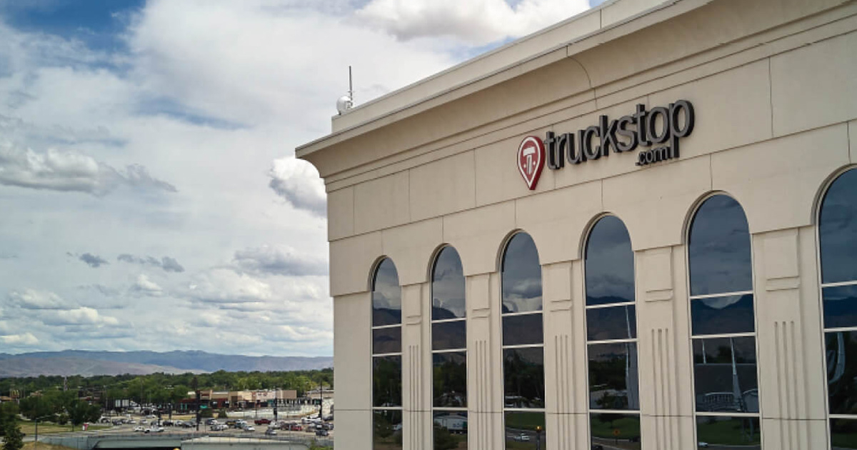 Trucker Path and Truckstop logos integrated with freight truck on highway