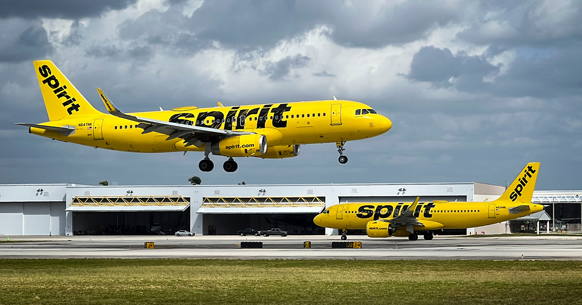 A Spirit Airlines airplane parked at an airport gate.