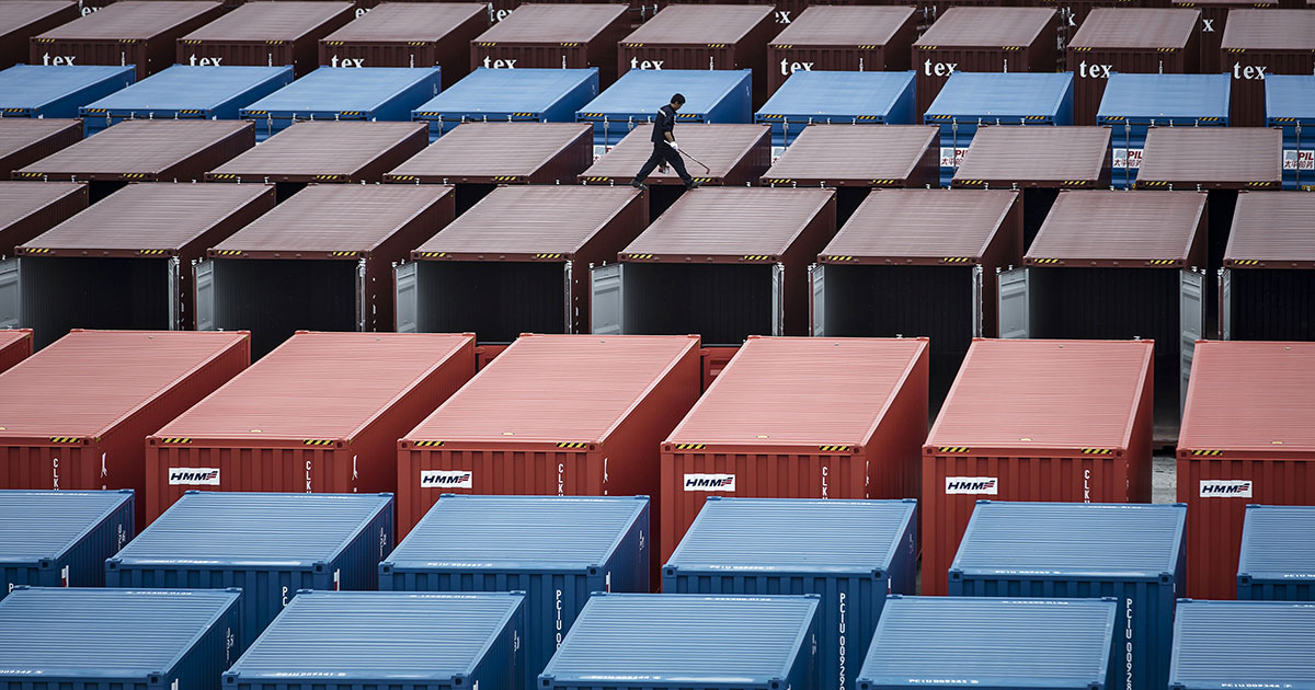 Justice Department seal with shipping containers in the background