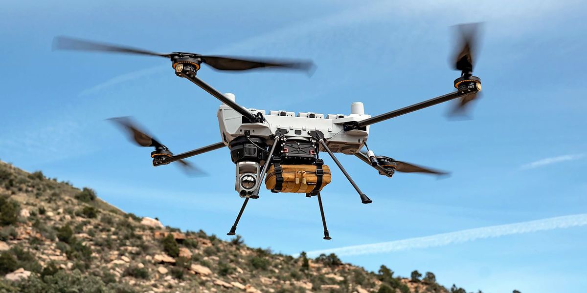 3D printer extruding flexible battery material onto a curved drone wing surface