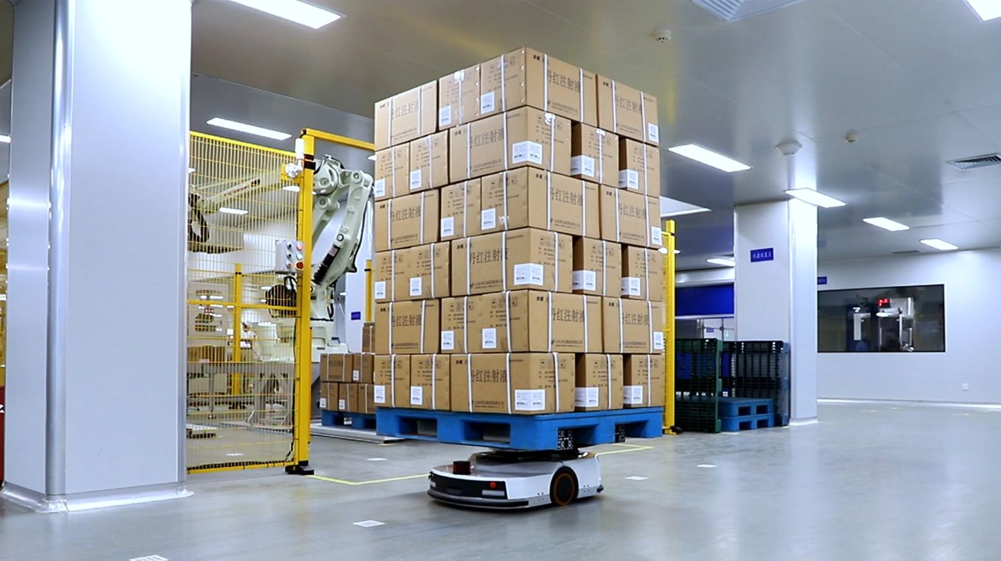 Robotic arms working in a modern factory setting.