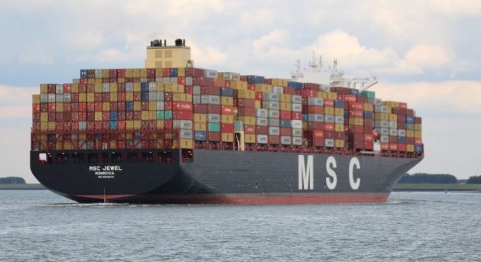 A bustling container port in China with numerous ships and cranes operating at full capacity.