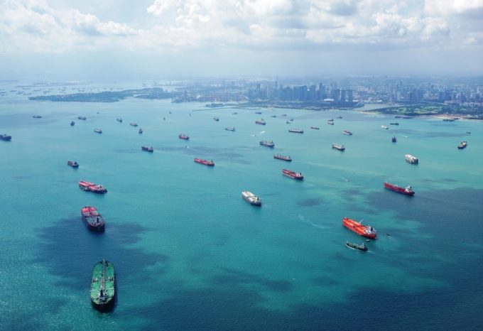 A container ship sailing on the ocean, with a focus on its modern design.