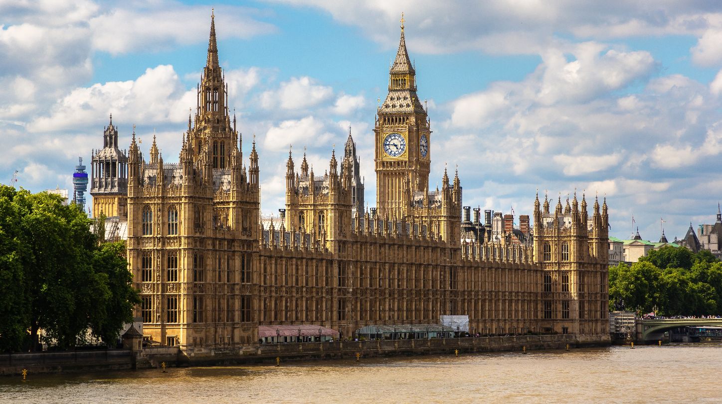 The Houses of Parliament in London, UK, with the Union Jack flag flying.