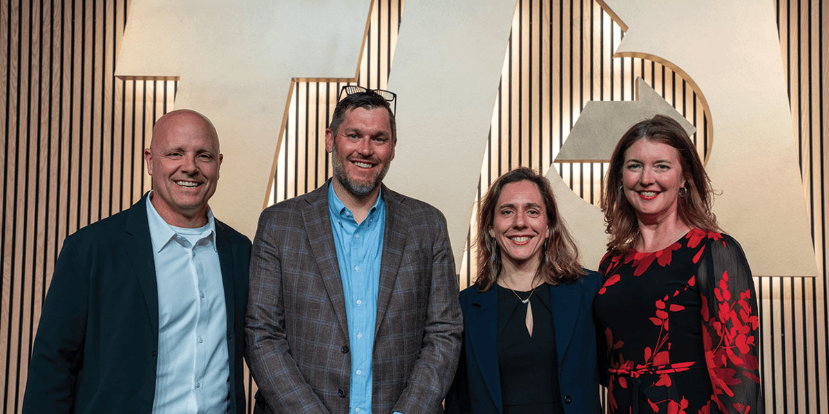 Aurélie Doucette smiling and holding a certificate or award.