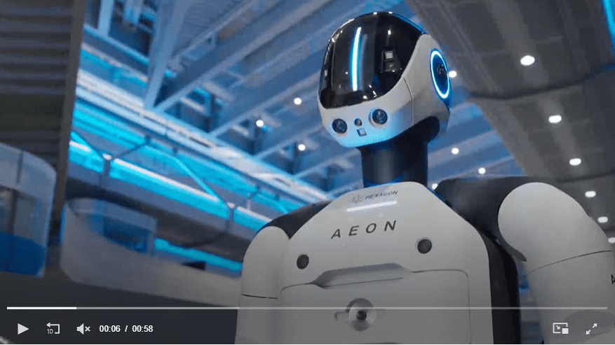 A humanoid robot arm performing a task on an assembly line at a BMW manufacturing plant.