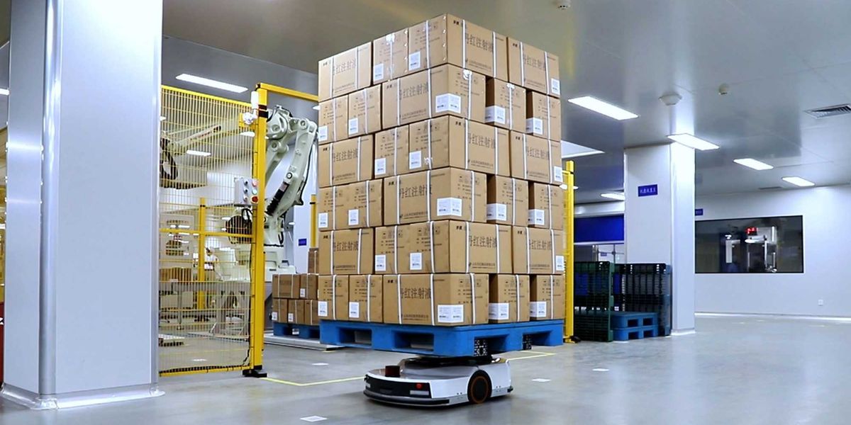 A close-up of a robotic arm performing a precise task on a factory assembly line.