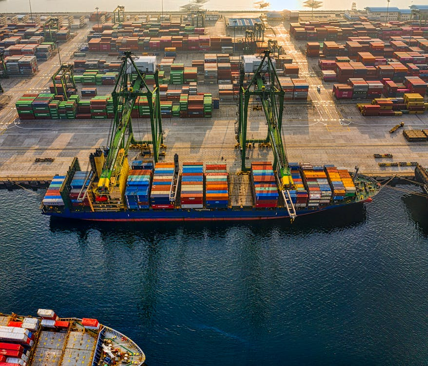 Container ships docked at a busy port with cargo being loaded and unloaded.