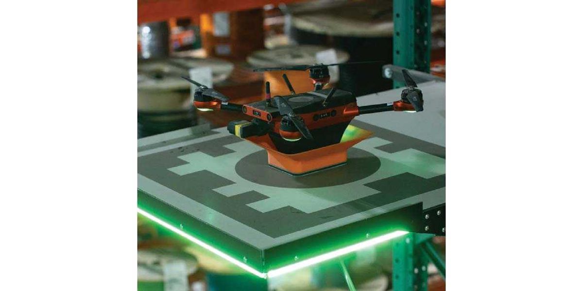 A Corvus Robotics autonomous inventory drone in flight within a warehouse aisle.