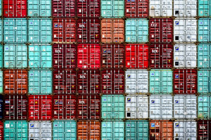 A large pile of shipping containers stacked high.